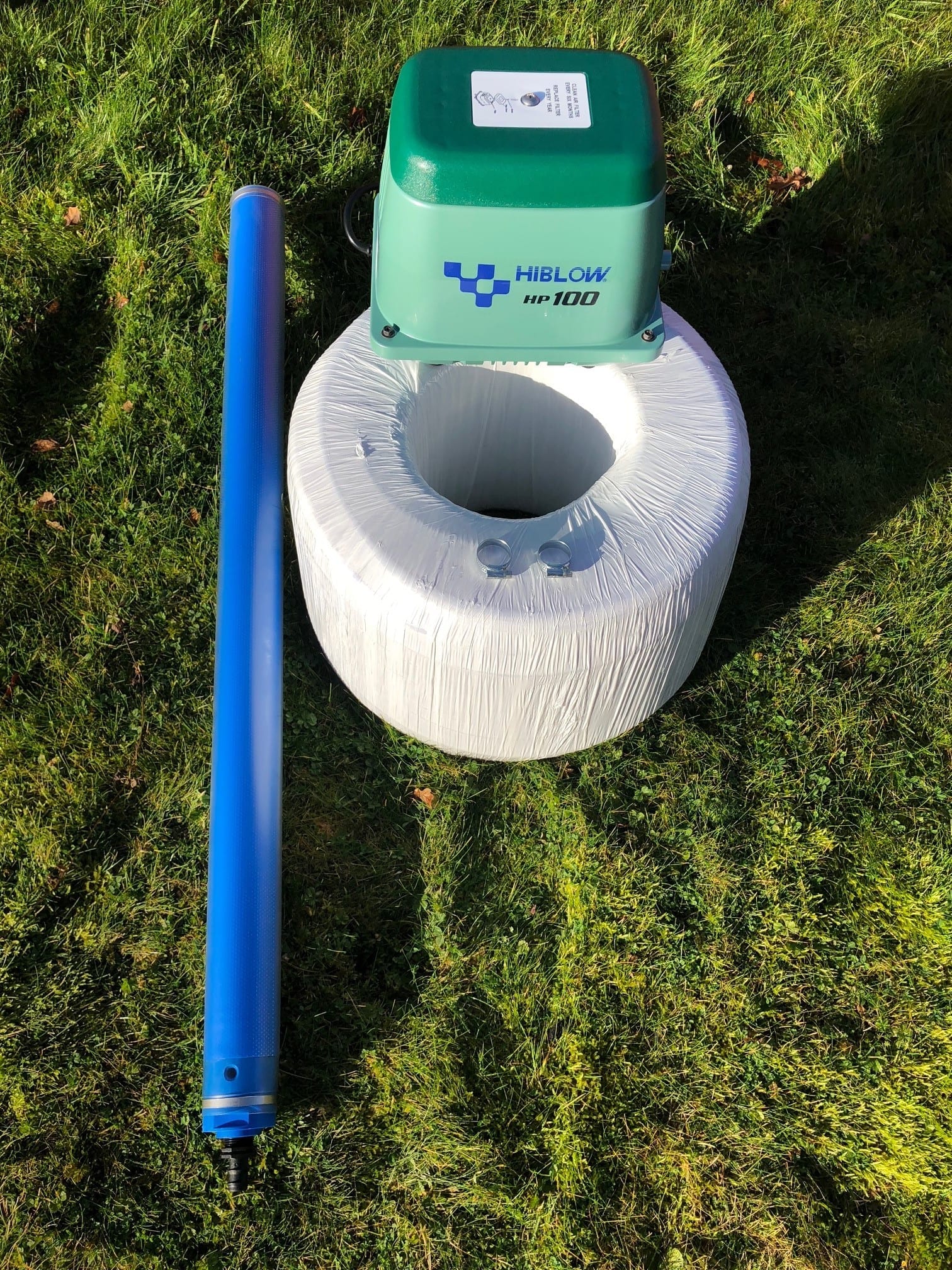Hiblow Small Pond and Lake Aeration Kit with air pump, 20m weighted airline, and fine-bubble diffuser installed in a pond.