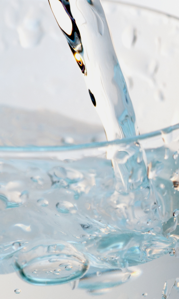 Purified water pouring into a glass